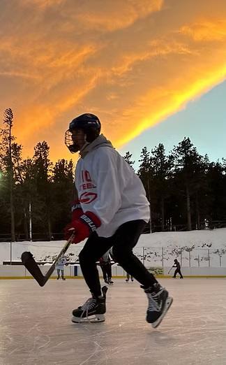 Hockey player silhouette with sunset behind